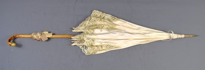 Lot 355 - An Edwardian satin, lace and bamboo parasol,...
