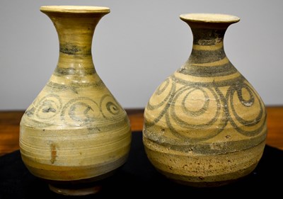 Lot 132 - Two ancient stoneware jugs with spiral designs,...