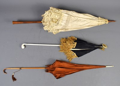 Lot 353 - A group of three Edwardian parasols, one...