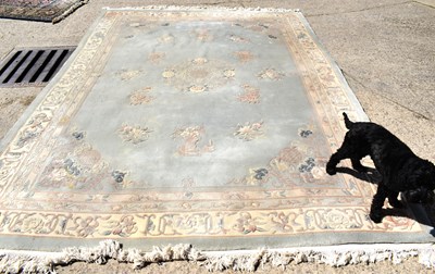 Lot 542 - A large Chinese rug,  light blue ground with a...