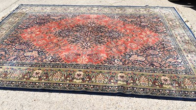 Lot 543 - A large Middle Eastern wool rug, with central...