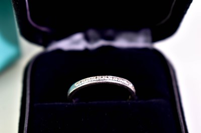 Lot 10 - A Tiffany & Co. platinum and diamond half hoop...