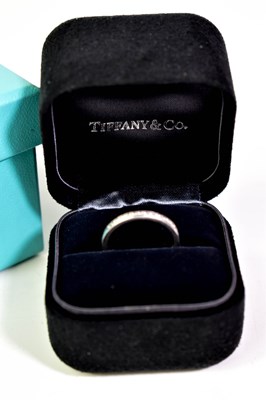 Lot 10 - A Tiffany & Co. platinum and diamond half hoop...
