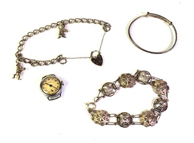 Lot 23 - A silver charm bracelet together with a silver...