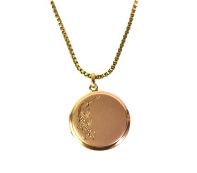 Lot 231 - An 18ct gold photo locket pendant on a gold...