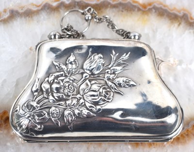 Lot 305 - An Edwardian silver purse with embossed floral...