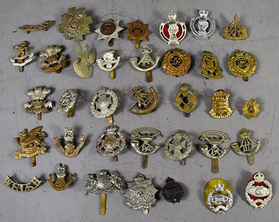Lot 278 - A group of WWI and later military cap badges...