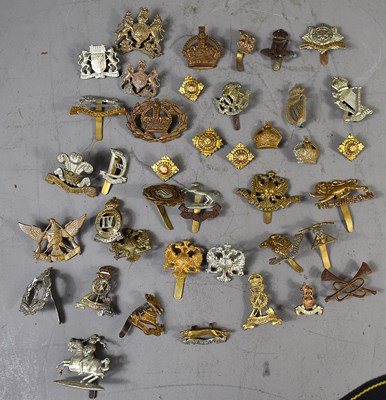 Lot 286 - A group of WWI and later military cap badges...