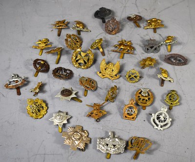 Lot 283 - A group of WWI and later military cap badges...