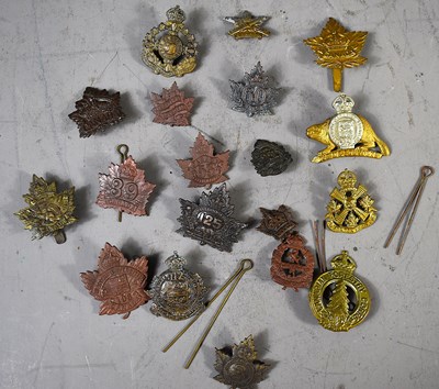 Lot 284 - A group of WWI and later military cap badges...