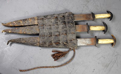 Lot 276 - A group of three Sudanese short swords /...