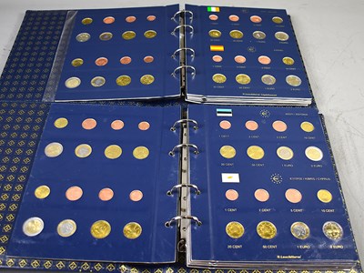 Lot 27 - Two folders of Euro coin sets from various...