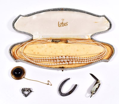 Lot 64 - A yellow metal and bulls eye agate brooch...