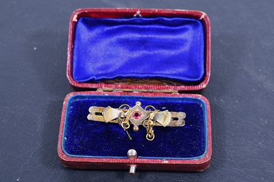 Lot 83 - An Edwardian 9ct gold bar brooch, set with a...
