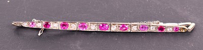 Lot 72 - A silver tennis bracelet set with pink and...