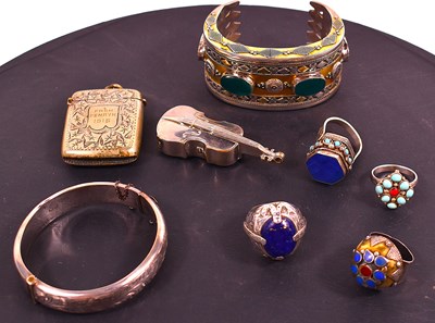 Lot 69 - A silver bangle with engraved decoration...