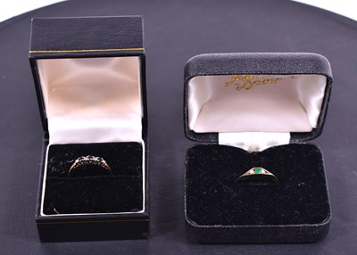 Lot 81 - Two 9ct gold rings, one set with emerald and...