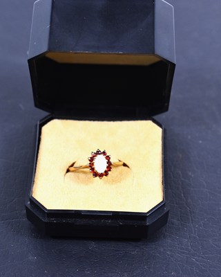 Lot 80 - A 9ct gold, garnet and opal ring, size N/M, 1.6g.