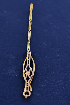Lot 91 - A 9ct gold tie clip and chain with pierced...