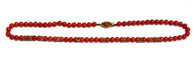 Lot 74 - A 9ct gold and coral necklace on a decorative...