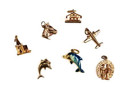 Lot 218 - A group of 9ct gold charms to include dolphin,...