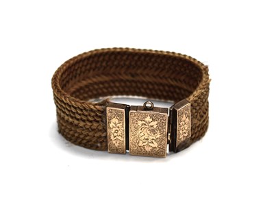 Lot 109 - A Victorian braided hair bracelet with yellow...