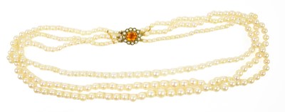 Lot 232 - A three strand graduated pearl necklace on a...