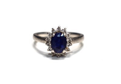 Lot 243 - A platinum, diamond and sapphire ring, size N,...