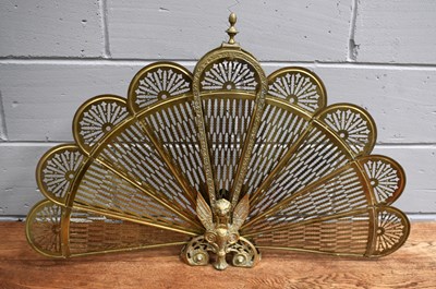 Lot 522 - A vintage brass folding peacock fire guard,...