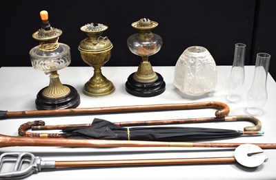 Lot 513 - Three antique oil lamps, two with clear glass...