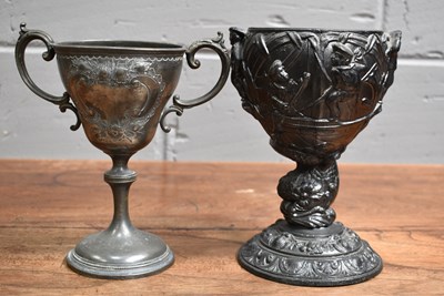 Lot 515 - An antique pewter chalice decorated in relief...