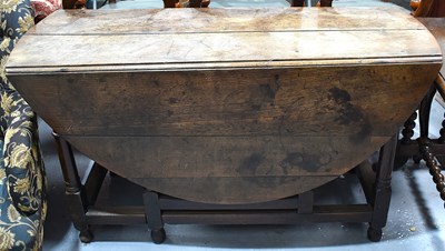 Lot 551 - An 18th century oak drop leaf gate leg dining...