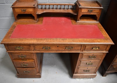 Lot 552 - A late Victorian oak pedestal desk with red...