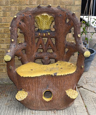 Lot 156 - An impressive terracotta faux bois armchair by...