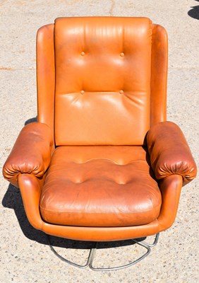 Lot 542 - A Schreiber tan leather swivel easy chair,...