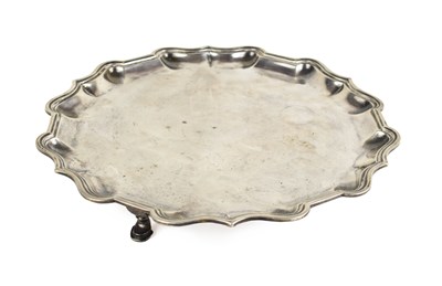 Lot 374 - A large silver salver, scalloped edge, raised...
