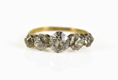Lot 254 - An 18ct gold and platinum five stone diamond...