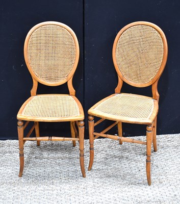Lot 473 - A pair of oval cane back dining chairs with...