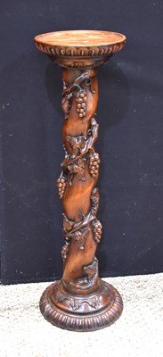 Lot 520 - A carved mahogany torchere pedestal, spiral...