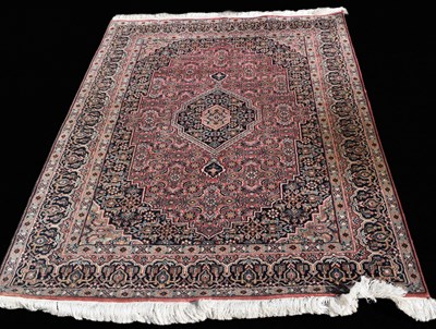 Lot 463 - A Persian style wool area rug featuring a...