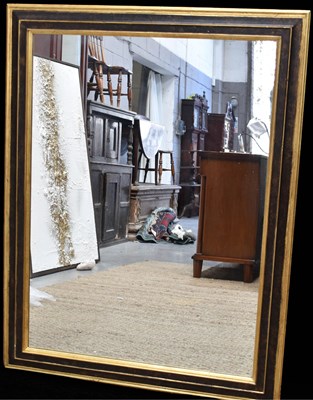 Lot 456 - A modern ebonised and giltwood moulded mirror,...