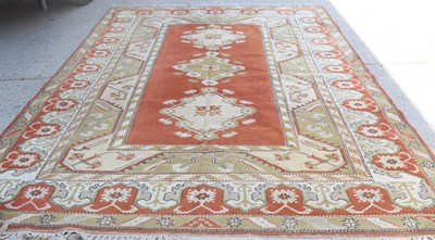 Lot 459 - A large wool rug, orange ground, diamond...