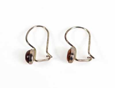 Lot 22 - A pair of silver and amber hoop earrings, set...