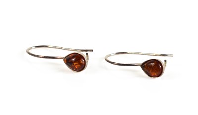 Lot 22 - A pair of silver and amber hoop earrings, set...