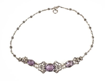 Lot 72 - A silver and amethyst necklace, the ornate...