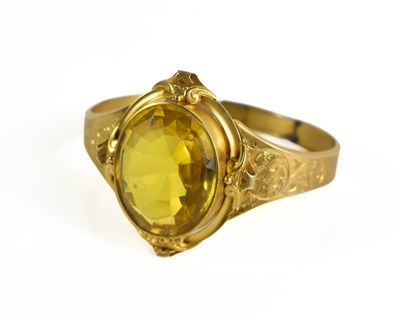Lot 212 - A gold Victorian and yellow stone bangle, the...