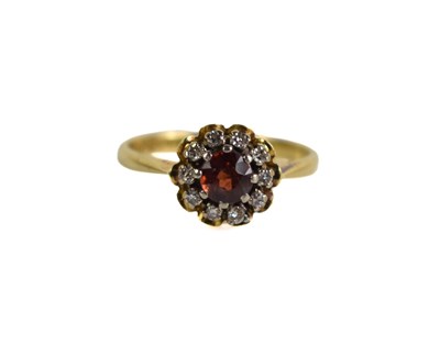 Lot 170 - An 18ct gold, diamond and garnet ring, the...