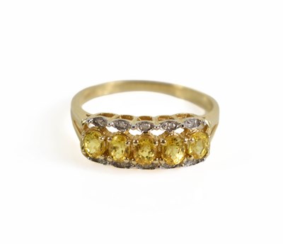Lot 112 - A 9ct gold, yellow sapphire and diamond ring,...