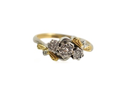 Lot 199 - An 18ct gold and diamond three stone ring, the...