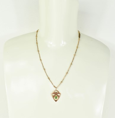 Lot 150 - An Art Nouveau 9ct rose gold and peridot...